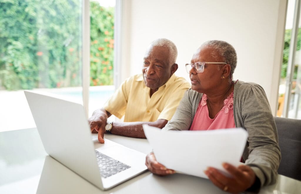 Senior couple reading Senior Living Buy-in Vs. Monthly Rent: Which Option Works Best for You?