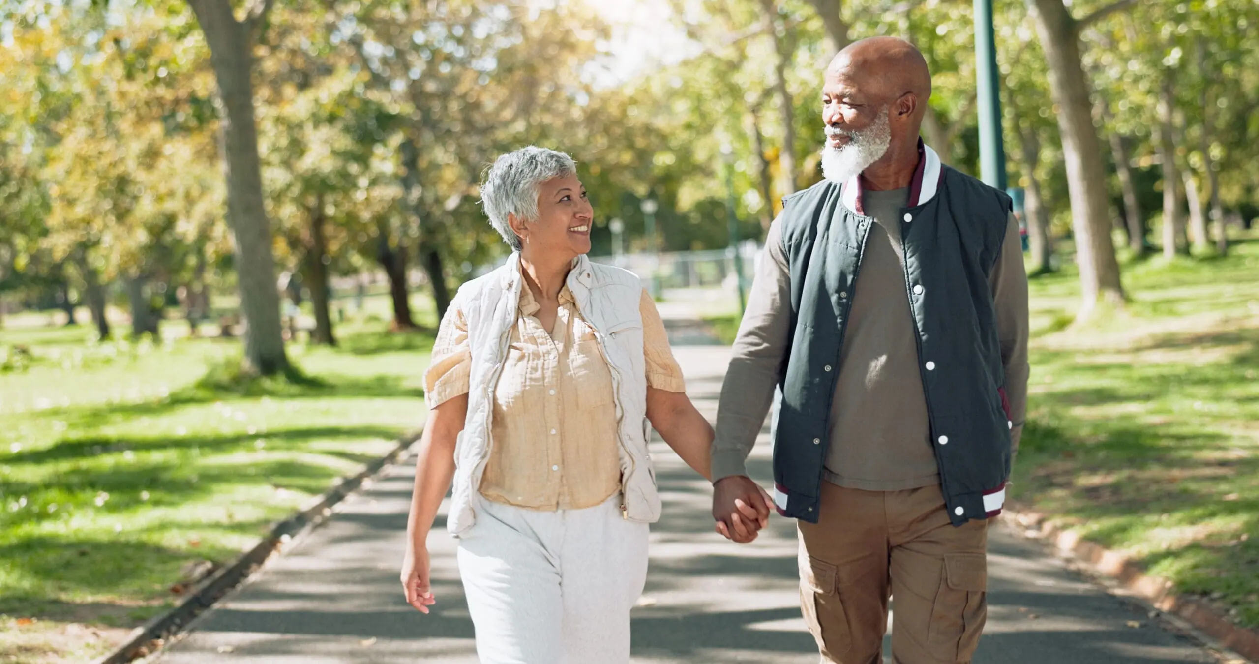 wearing best walking shoes for seniors, a mature couple strolls through park