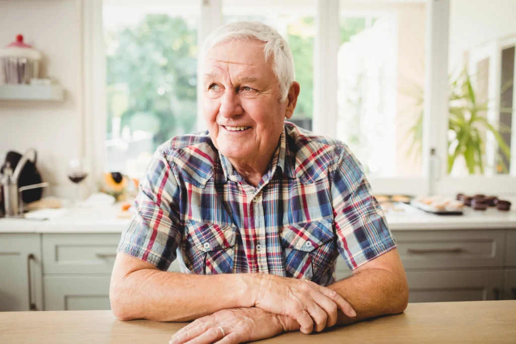 senior man sitting in kitchen
