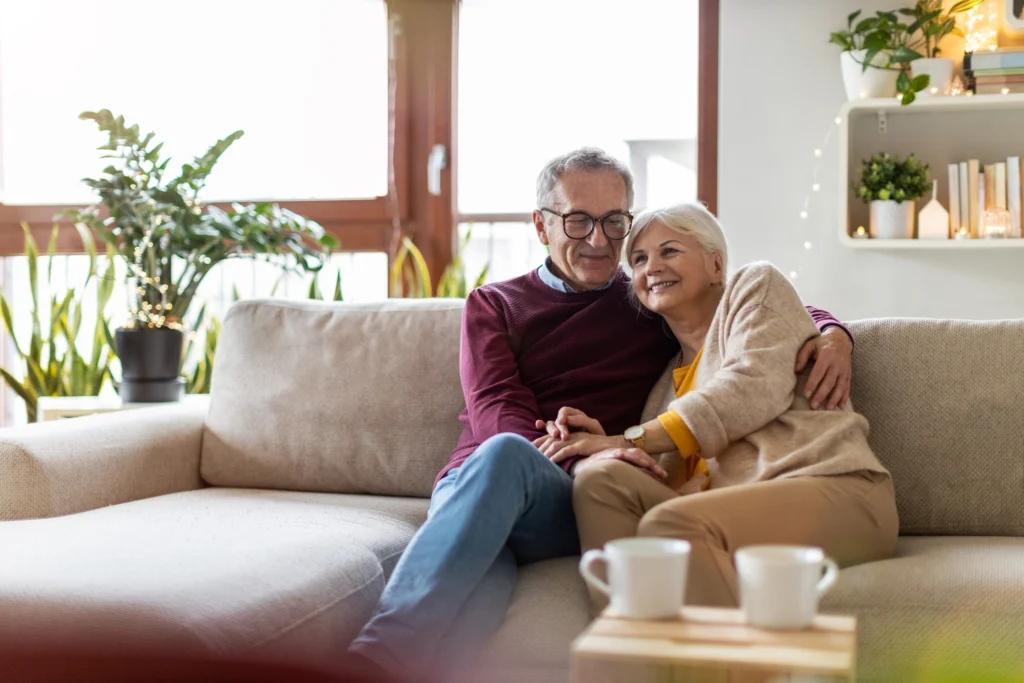 older couple snuggles on couch