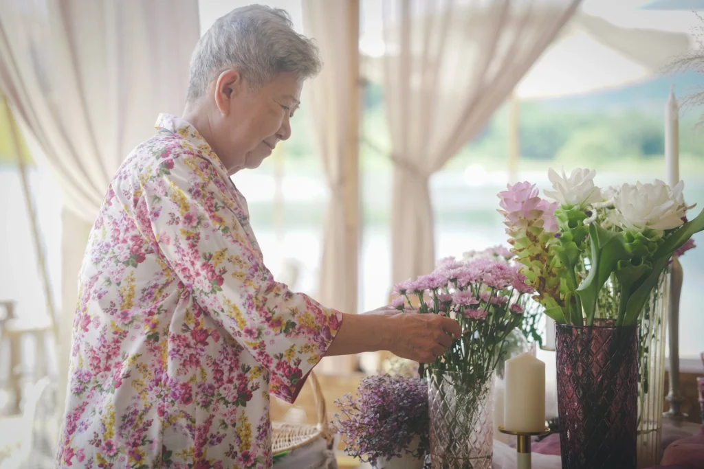 senior woman decorating a senior living apartment 