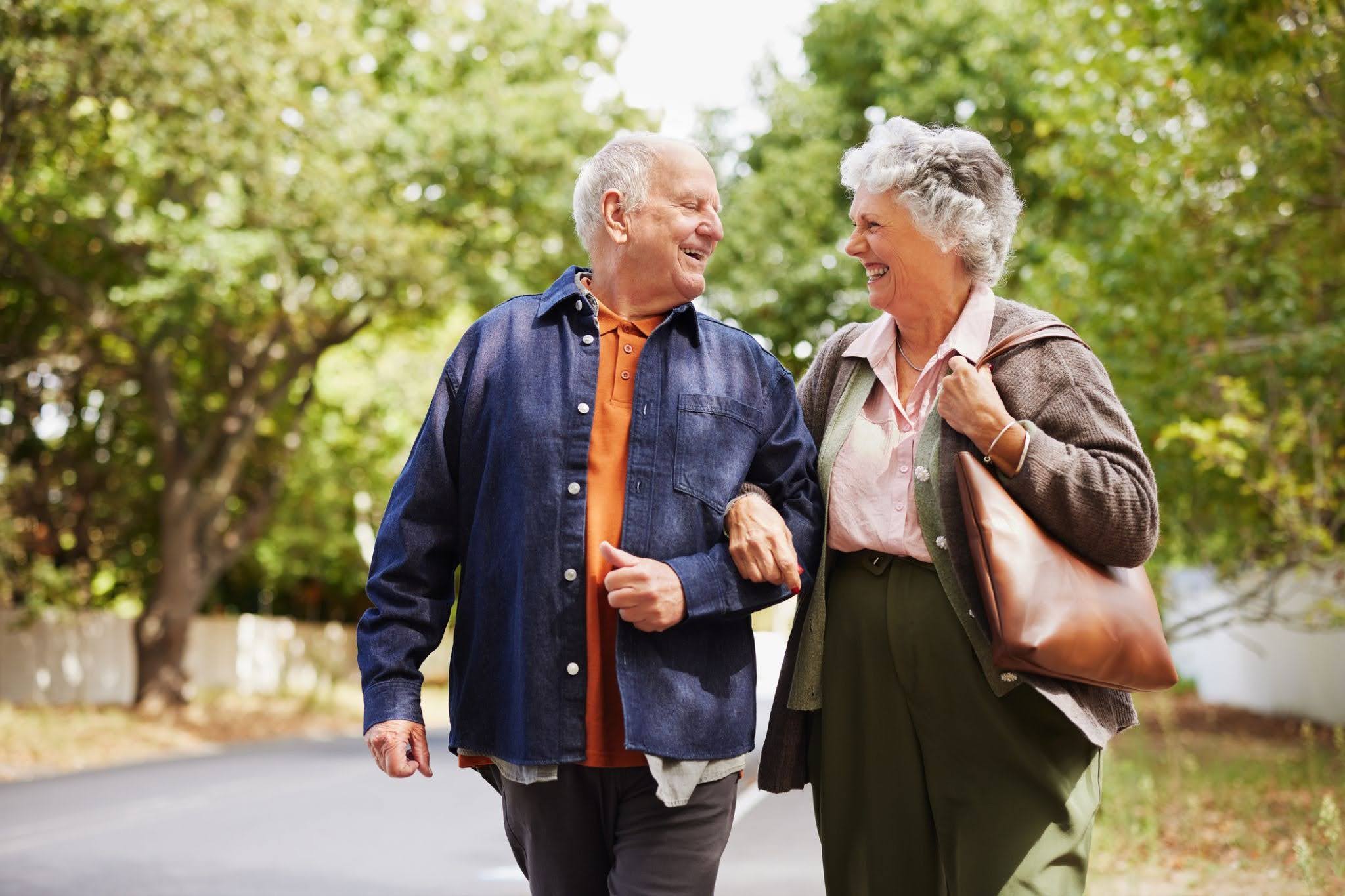 senior-couple-walk Senior couple enjoying the ease of modern senior living at The Merion