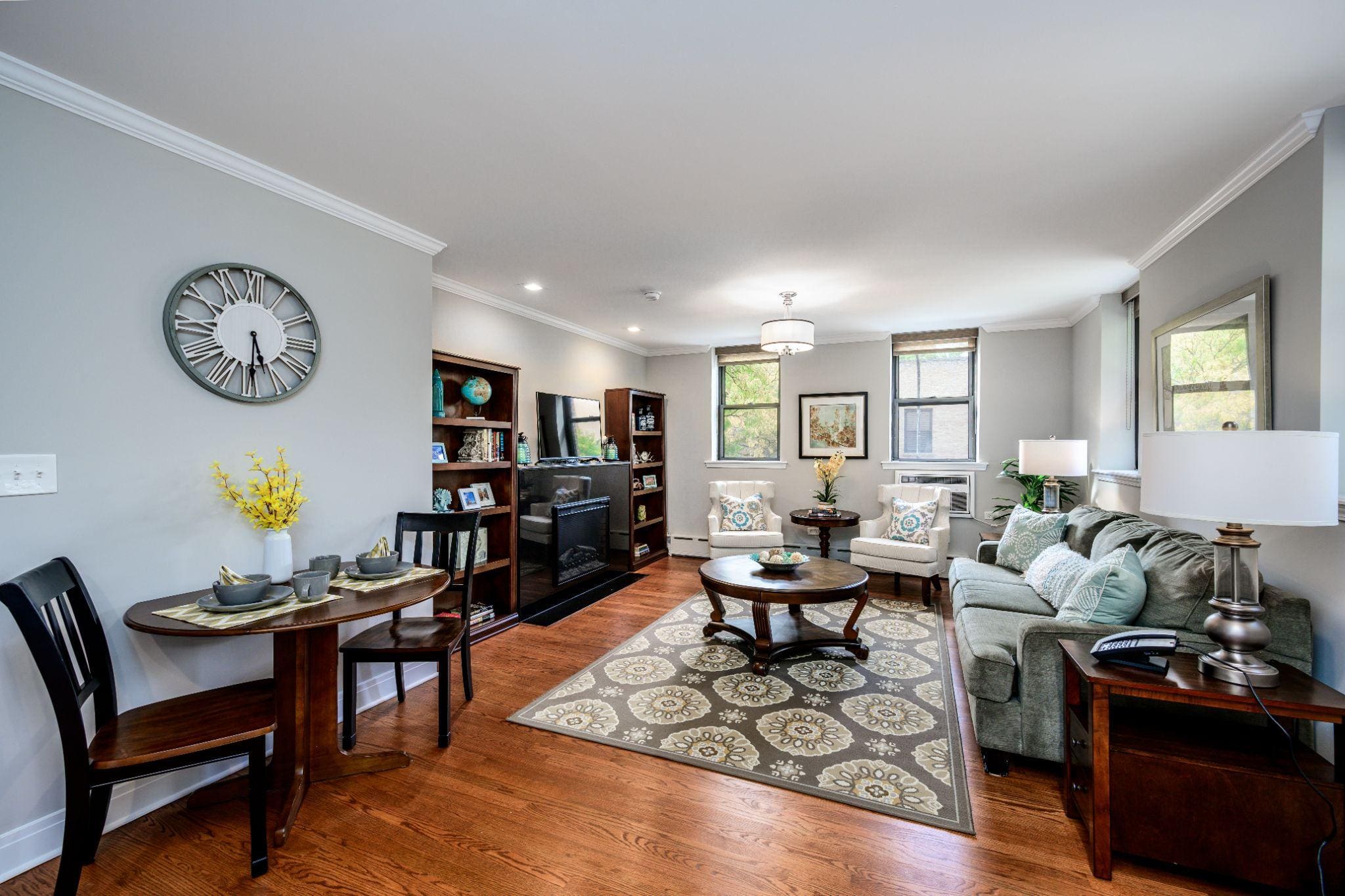 The inside of a rental senior apartment for residents at The Merion in Evanston, IL featuring a spacious living room with modern furniture in a bright colored room.
