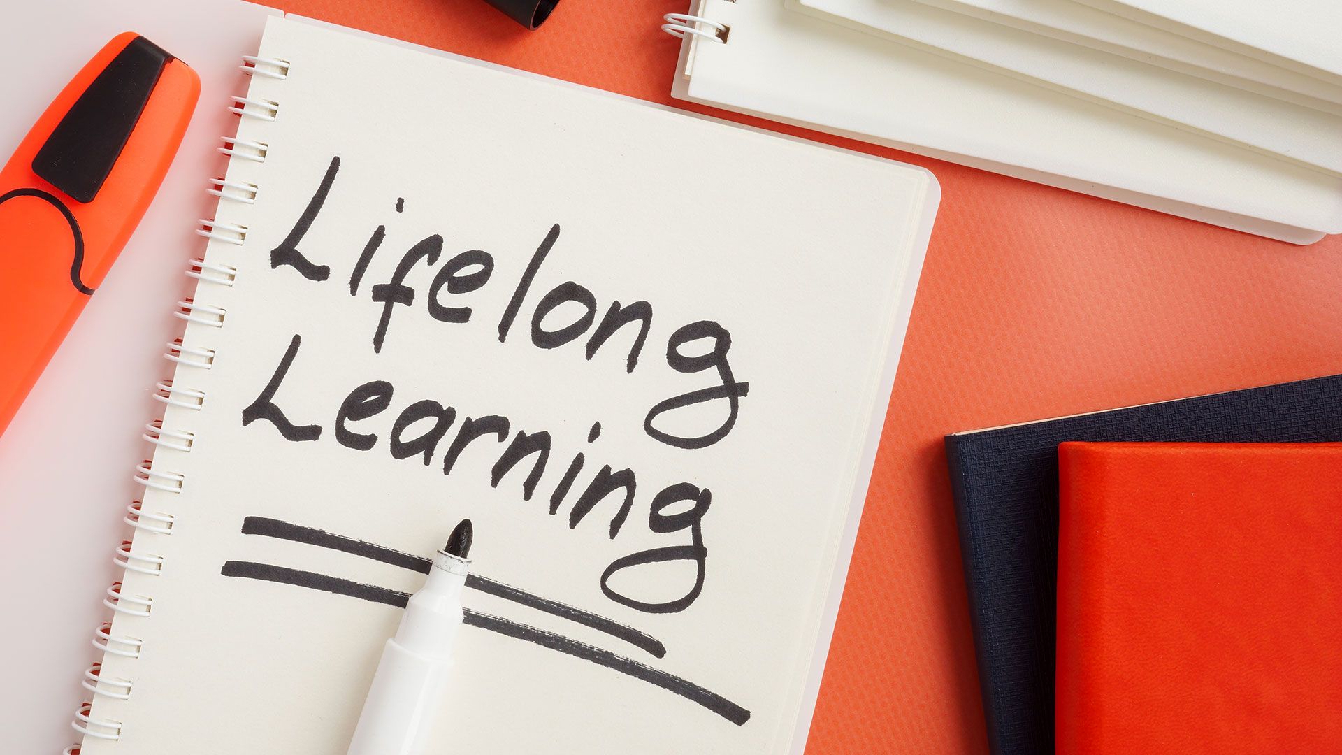 Notepad with the words "Lifelong Learning" hand-written on it.