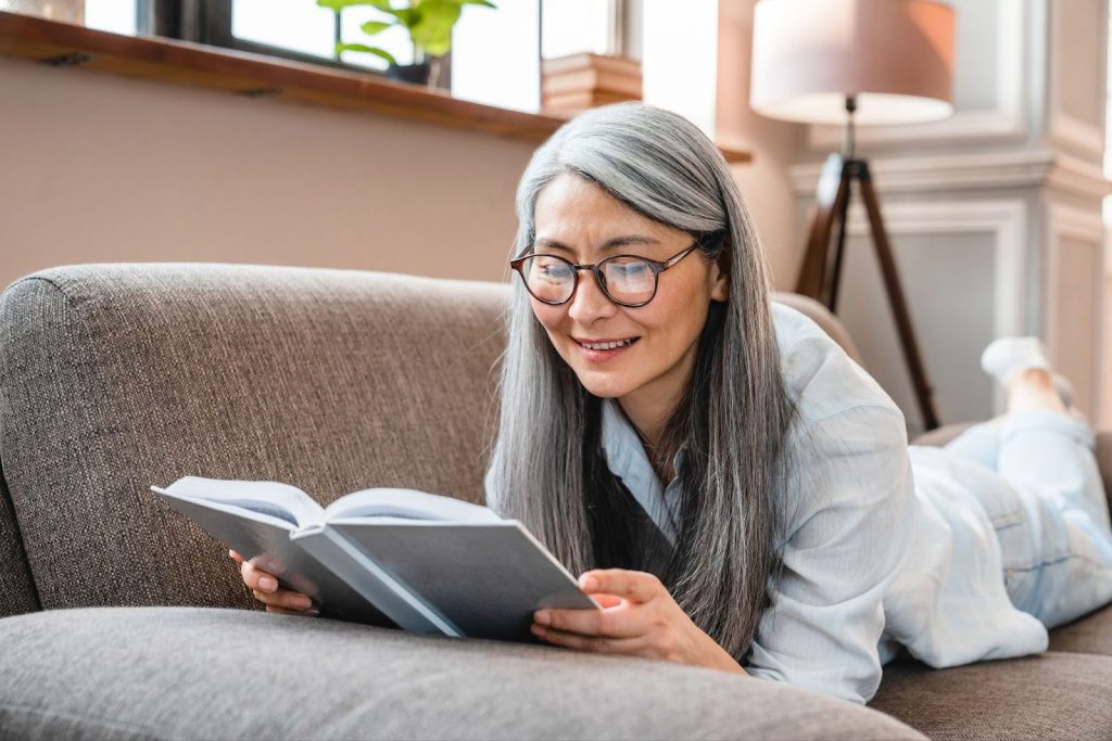 Senior woman reading a book on aging well